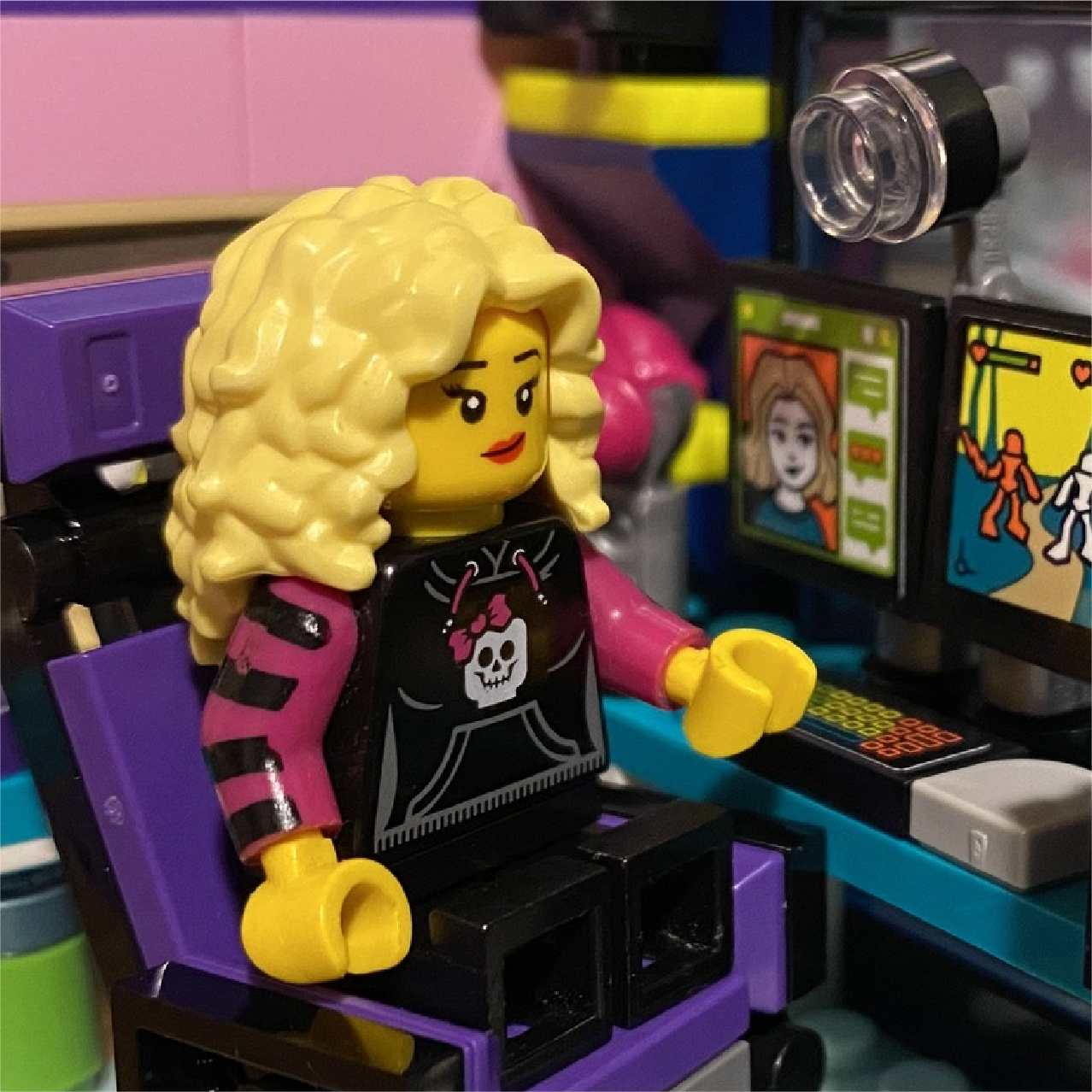 An image of a lego minifigure sitting at a desk